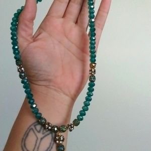 Shiny turquoise blue beaded necklace with clear gemstones in gold tone settings